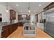 Spacious kitchen boasts hardwood floors, a center island, and stainless steel appliances at 3311 Canoe Brook Pkwy, Raleigh, NC 27614