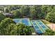Aerial view of well-maintained community tennis and pickleball courts in a lush, green setting at 3311 Canoe Brook Pkwy, Raleigh, NC 27614