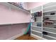 Walk-in closet with white shelving and hanging racks for organized storage at 3311 Canoe Brook Pkwy, Raleigh, NC 27614