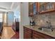 Charming wet bar featuring granite counters, tile backsplash, and glass-front cabinets at 3311 Canoe Brook Pkwy, Raleigh, NC 27614