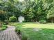 Private backyard with stone walkway and manicured landscaping, perfect for outdoor living at 334 Dell Meadows Pl, Four Oaks, NC 27524