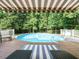 Backyard oasis featuring a refreshing pool and comfortable lounging area at 334 Dell Meadows Pl, Four Oaks, NC 27524
