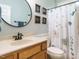 Stylish bathroom with framed decor, a pedestal sink, and a shower-tub combo at 334 Dell Meadows Pl, Four Oaks, NC 27524