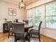 Cozy dining area with a round table, four chairs, and natural light from the windows at 334 Dell Meadows Pl, Four Oaks, NC 27524