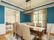 Elegant dining room with stylish lighting, wainscoting, and a view of the entryway at 334 Dell Meadows Pl, Four Oaks, NC 27524