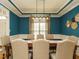 Stylish dining room with crown molding, modern chandelier, and seating for eight at 334 Dell Meadows Pl, Four Oaks, NC 27524