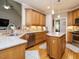 Well-lit kitchen with granite countertops, stainless steel appliances, and hardwood floors at 334 Dell Meadows Pl, Four Oaks, NC 27524