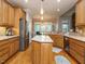 Spacious kitchen featuring wood cabinets, stainless steel appliances, and a granite-topped island at 334 Dell Meadows Pl, Four Oaks, NC 27524