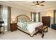 Tranquil main bedroom with a ceiling fan, tray ceiling, and plenty of natural light at 334 Dell Meadows Pl, Four Oaks, NC 27524