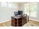 Comfortable office space with a wooden desk, two monitors, and a patterned rug at 334 Dell Meadows Pl, Four Oaks, NC 27524