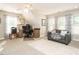 Bright office space features large windows, a sofa, and a wooden desk at 334 Dell Meadows Pl, Four Oaks, NC 27524