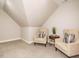 Cozy room with two armchairs, a side table, and neutral carpet flooring at 334 Dell Meadows Pl, Four Oaks, NC 27524