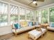 Inviting sunroom with ample seating, natural light, and views of the outdoors at 334 Dell Meadows Pl, Four Oaks, NC 27524