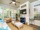 Relaxing sunroom featuring comfortable furniture, wood floors, and large windows at 334 Dell Meadows Pl, Four Oaks, NC 27524