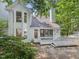 Two-story home exterior with a white deck and lush landscaping at 3811 Carnegie Ln, Raleigh, NC 27612