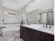 Bathroom features a double sink vanity, large mirror, bath tub, and modern fixtures at 3811 Carnegie Ln, Raleigh, NC 27612