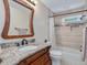 Renovated bathroom featuring a vanity with marble countertop and a tiled shower/tub combo at 3811 Carnegie Ln, Raleigh, NC 27612
