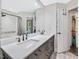 Bathroom features a double sink vanity with black hardware, large mirror, and shower with bathtub at 3811 Carnegie Ln, Raleigh, NC 27612