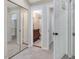 Open bedroom featuring mirrored closet doors and adjacent bathroom at 3811 Carnegie Ln, Raleigh, NC 27612