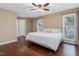 A cozy bedroom with a ceiling fan, natural light from two windows, and hardwood floors at 3811 Carnegie Ln, Raleigh, NC 27612