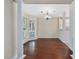Bright dining area featuring hardwood floors, large windows, and a stylish chandelier at 3811 Carnegie Ln, Raleigh, NC 27612