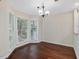 Bright dining area featuring hardwood floors and large windows with natural lighting at 3811 Carnegie Ln, Raleigh, NC 27612