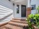 Covered home entrance with brick stairway and front door at 3811 Carnegie Ln, Raleigh, NC 27612