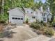 Home exterior featuring a garage, well-manicured lawn, and concrete driveway at 3811 Carnegie Ln, Raleigh, NC 27612