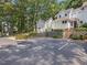 Home exterior with a detached garage, visitor parking, and tiered landscaping at 3811 Carnegie Ln, Raleigh, NC 27612