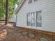 Exterior home side view with stepping stones, white siding, and large windows at 3811 Carnegie Ln, Raleigh, NC 27612