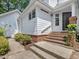Home exterior with brick steps leading to the front door and a well-maintained yard at 3811 Carnegie Ln, Raleigh, NC 27612