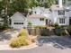 Home exterior with a garage, driveway, well-manicured lawn, and front entryway at 3811 Carnegie Ln, Raleigh, NC 27612