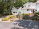 Home exterior with visitor parking, tiered landscaping, a detached garage, and sidewalk at 3811 Carnegie Ln, Raleigh, NC 27612