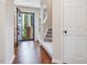 Inviting foyer with hardwood floors, staircase, and modern front door leading to bright, landscaped outdoors at 3811 Carnegie Ln, Raleigh, NC 27612