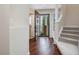 View of home foyer with wood floors, stairway, and front door at 3811 Carnegie Ln, Raleigh, NC 27612