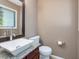 Stylish half bathroom featuring a modern vessel sink, granite countertop, and decorative mirror at 3811 Carnegie Ln, Raleigh, NC 27612