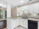 Bright kitchen featuring white cabinets, granite countertops, and modern appliances at 3811 Carnegie Ln, Raleigh, NC 27612