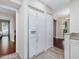 Bright kitchen featuring a white refrigerator with water dispenser and storage cabinets above at 3811 Carnegie Ln, Raleigh, NC 27612