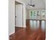 Spacious living room featuring gleaming hardwood floors, ceiling fan and access to the rear deck at 3811 Carnegie Ln, Raleigh, NC 27612