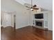 Bright and airy living room featuring hardwood floors, fireplace, and access to other living spaces at 3811 Carnegie Ln, Raleigh, NC 27612