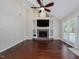 Open living room with vaulted ceiling, fireplace, built-ins, hardwood floors, and access to deck at 3811 Carnegie Ln, Raleigh, NC 27612