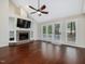 Open living room with vaulted ceiling, fireplace, built-ins, hardwood floors, and access to deck at 3811 Carnegie Ln, Raleigh, NC 27612