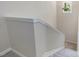 Carpeted staircase with white trim and a small window at 3811 Carnegie Ln, Raleigh, NC 27612