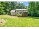 The property features a home with a screened in porch and spacious backyard with mature trees at 3821 Whispering Branch Rd, Raleigh, NC 27613