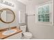 Cozy bathroom has a unique mirror and window, ensuring lots of natural light at 3821 Whispering Branch Rd, Raleigh, NC 27613