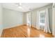 Light-filled bedroom features hardwood floors and a ceiling fan, providing a comfortable and inviting space at 3821 Whispering Branch Rd, Raleigh, NC 27613