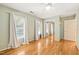 Bedroom with hardwood floors and mirrored closet doors, offering ample storage space at 3821 Whispering Branch Rd, Raleigh, NC 27613