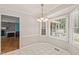 Bright breakfast nook with bay window next to the living room with brick fireplace at 3821 Whispering Branch Rd, Raleigh, NC 27613