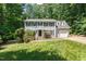 Traditional two-story home boasts a manicured lawn and classic architectural details at 3821 Whispering Branch Rd, Raleigh, NC 27613