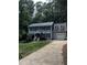 Charming two-story home with a gray exterior, black shutters, and a well-manicured front lawn at 3821 Whispering Branch Rd, Raleigh, NC 27613